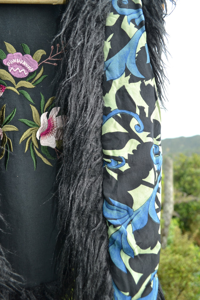 Front view of Midnight Rose Mongolian Vest with blue and black vintage silk sari lining and floral embroidery