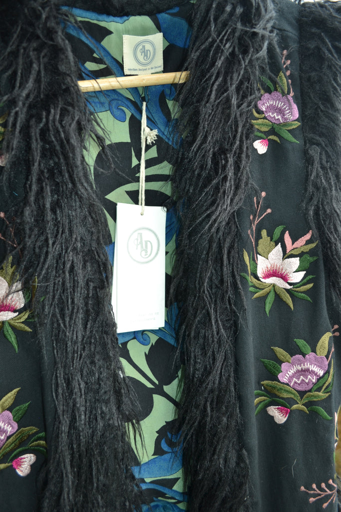 Artistic shot of the blue and black swirling vintage silk lining framed by faux fur trim