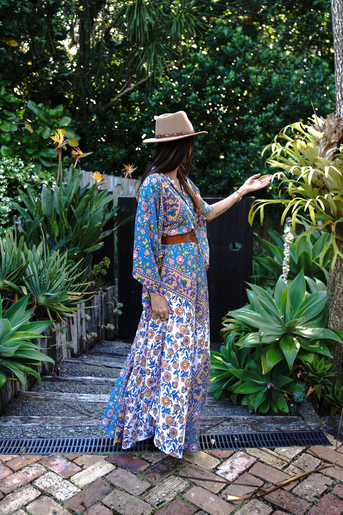 Side view of the Wildflower Kaftan with the skirt moving as the model walks, showing the lightweight organic cotton and floral design